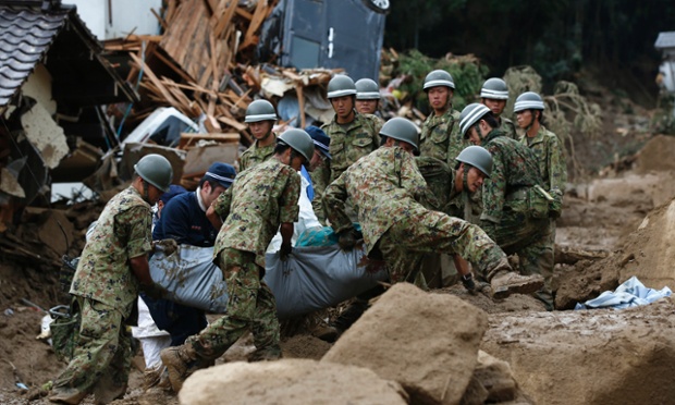 Japan Self-Defense Force soldiers carry the body of a victim following a landslide in Hiroshima, Japan