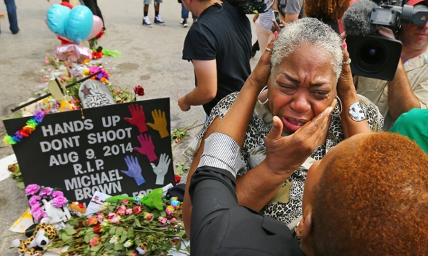 Spiritual teacher Iyanla Vanzant, right, consoles Canfield Apartments resident, Shirley Scale, at the shrine to Michael Brown where he was shot and killed in Ferguson, Missouri.