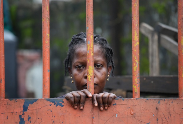 A slum resident looks out on the second day of the government's Ebola quarantine on their area of Monrovia, Liberia