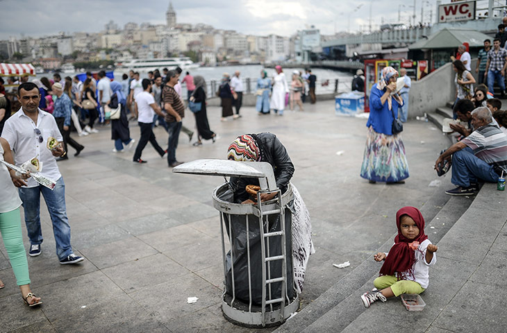 20 Photos: A Syrian refugee eats food which her mother took from a bin in Istanbul