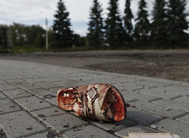 20 Photos: A bloodstained shoe on a street after recent shelling in Makiivka, Ukraine