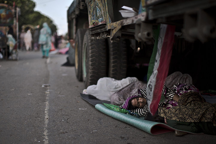 20 Photos: A supporter of anti-government cleric Tahir-ul-Qadri sleeps in Islamabad