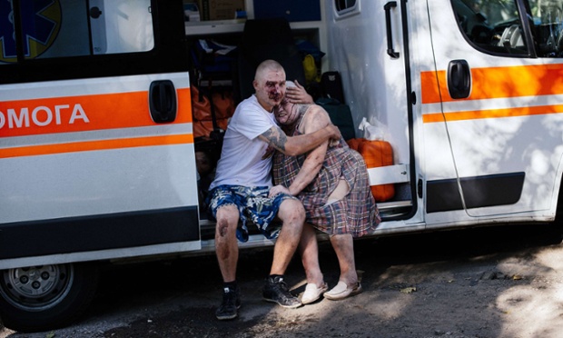 Donetsk, Ukraine: An injured man hugs a woman as they sit in an ambulance after shelling in eastern Ukraine.
