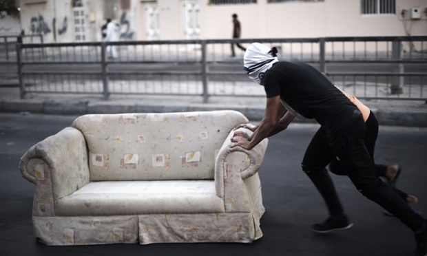 Jidhafs, Bahrain: Bahraini protesters block the road with a sofa during clashes with riot police following an anti-government protest