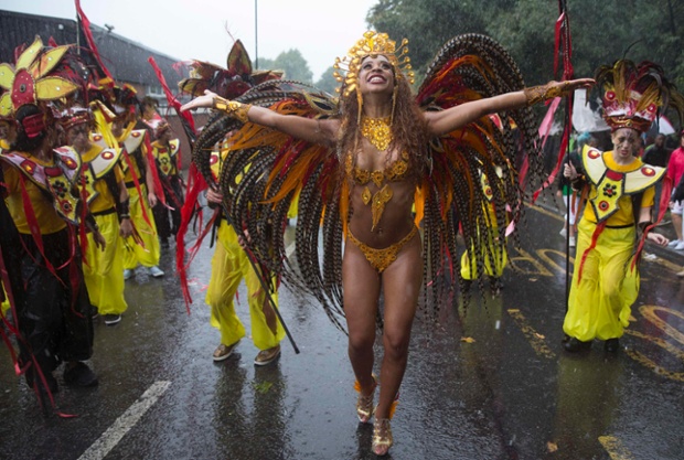 Raindance - Performers don't let the weather dampen the party at the Notting Hill Carnival in west London