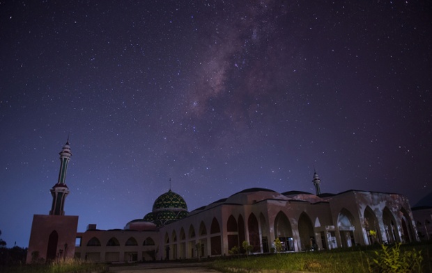 A clear night view of Milky Way galaxy above a mosque on in Natuna Island, Indonesia