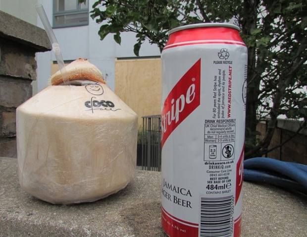coconut water and a can of beer on a wall