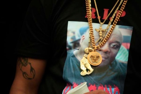photo of a man's torso with a t shirt and gold chains around his neck