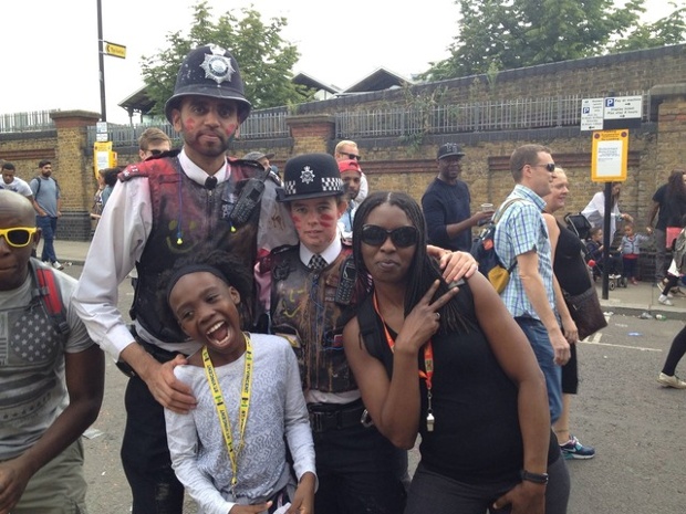two police officers posing with a woman and a girl