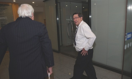 Former senior Howard advisor Grahame Morris opens the door for Clive Palmer as he arrives for a morning meeting of the Palmer United Party at their offices  in the National Press club building, Tuesday 26th August 2014