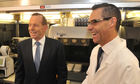 Prime Minister Tony Abbott (L) shares a joke with Ricky Johnstone, Assistant Director of Research at the Peter McCallum hospital in Melbourne, Tuesday, Aug. 26, 2014.