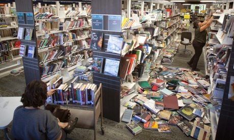 Library workers sort and re-shelve books after the earthquake in San Francisco Bay