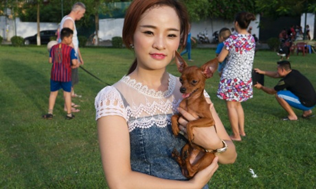 Woman with pet dog in Hanoi park