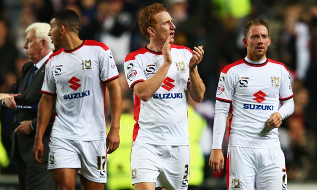 MK Dons captain Dean Lewington applauds the fans after his team's famous 4-0 victory.