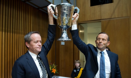 The Prime Minister Tony Abbott with the leader of the Opposition Bill Shorten and the AFL 2014 premiership cup at the parliamentary friends of AFL launch function in Parlaiment House Canberra