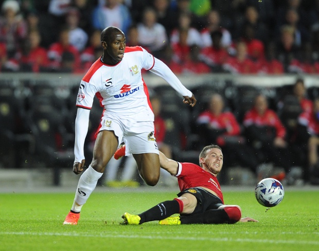 With six minutes to go MK Dons's Benik Afobe goes through three half-hearted United challenges ...