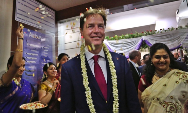 Airbus employees throw flower petals to welcome Nick Clegg to their facility in Bangalore, India