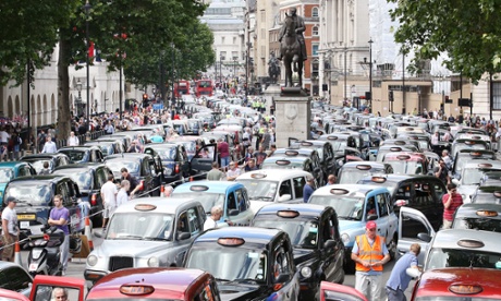 Taxis blockade Whitehall on June 11, 2014 in London, campaigning against the introduction of the 'Uber' taxi smartphone app in the United kingdom.