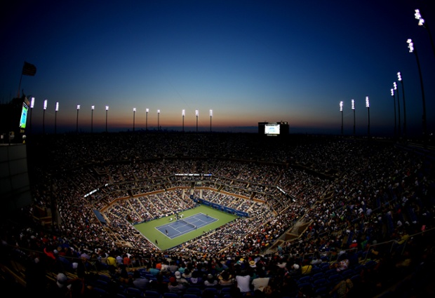 The sun sets as Roger Federer of Switzerland plays against Marinko Matosevic  in the US Open, in the Queens borough of New York