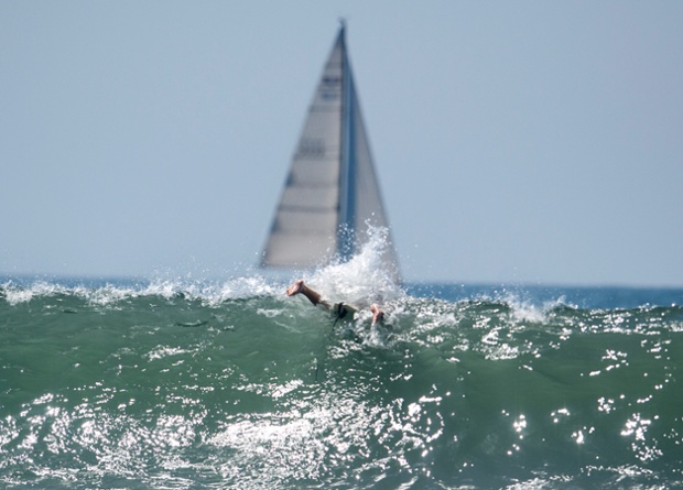 A surfer cuts through a wave at Venice Beach, as California awaits the effects of Hurricane Marie