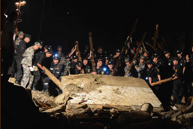 Rescue workers search the site of a landslide in Fuquan China