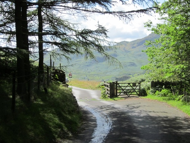 'The clouds rolled back to let the sun shine through briefly: After a morning of torrential rain, the sun came out to shine on Langdale Pikes.'