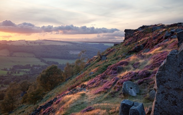 'Evening Light on Curbar Edge: The rays of the declining sun illuminate the rock faces and heather on Curbar Edge in Derbyshire on 20 August.'