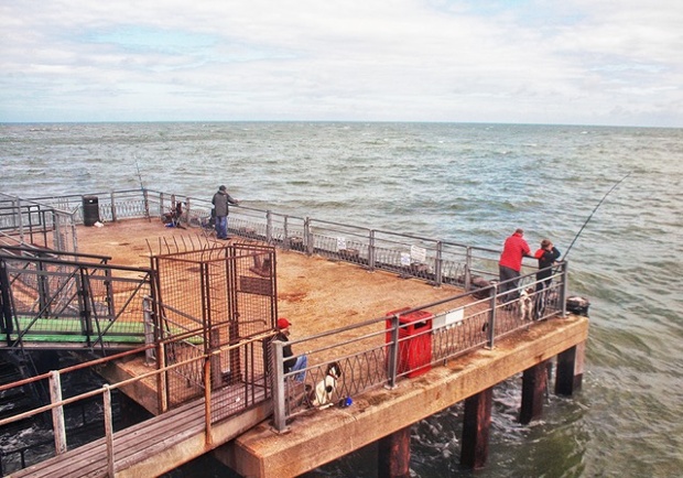 'Fishing on Llandudno Pier: The fishing platform on the end of Llandudno Pier is rather ramshackle but popular with fish men. The rough sea last Wednesday made for a particularly good catch.'