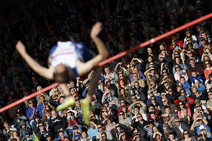 sport: The crowd watch and shade their eyes as
