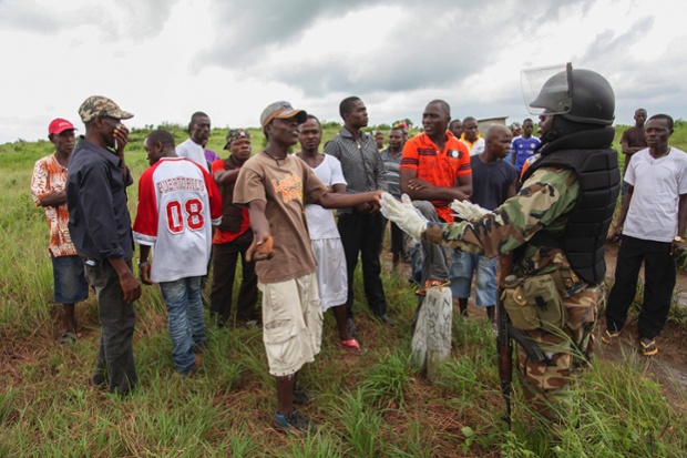 Men protest against the burial of victims of the Ebola virus in their community outside Monrovia, Liberia