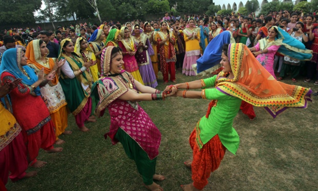 Women sing folk songs and perform a folk dance from the Punjab during the Teej festival in Amritsar