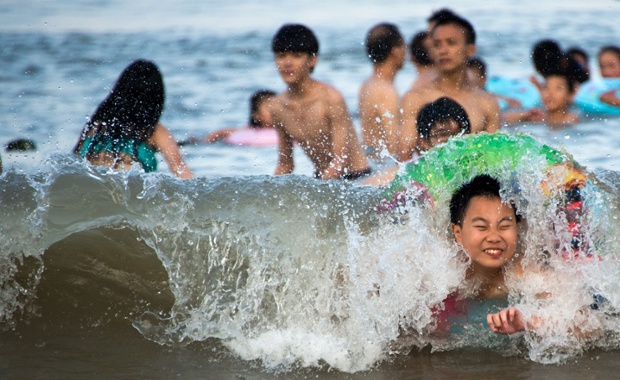 Children play on the beach in Xiangshan on the East China Sea