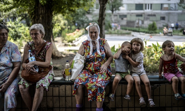 Refugees wait in front of a hostel building ran by pro-Russian rebels in the center of Donetsk