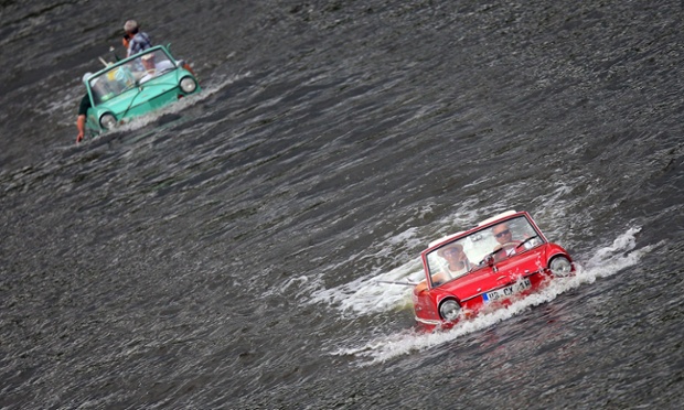People drive with amphibian vehicles in the river Mosel near Traben-Trabach, southern Germany on August 2, 2014 during the 