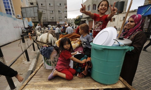 Displaced Palestinians leave a United Nations (UN) school in Beit Lahia in the northern Gaza Strip to return to their homes on August 5, 2014, after a 72-hour ceasefire between Israel and Hamas in the Gaza Strip brokered by Egypt came into effect at 8:00 am.  The Israeli army said it would withdraw completely from the Gaza Strip, when the agreed ceasefire with Hamas takes effect. AFP PHOTO/ MOHAMMED ABEDMOHAMMED ABED/AFP/Getty Images plg