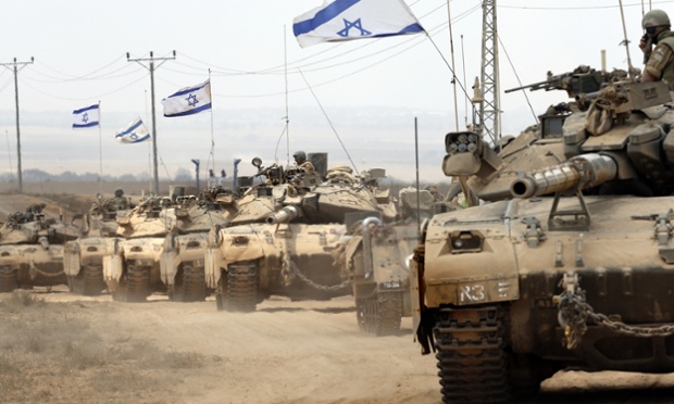 Israeli Merkava tanks roll near the border between Israel and the Gaza Strip as they return from the Hamas-controlled Palestinian coastal enclave on August 5, 2014, after Israel announced that all of its troops had withdrawn from Gaza. Israel completed the withdrawal of all troops from Gaza as a 72-hour humanitarian truce went into effect following intense global pressure to end the bloody conflict.