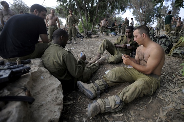 Israeli soldiers play cards near the border between Israel and the Gaza Strip, as Israel announced that all of its troops had withdrawn from the Gaza Strip.
