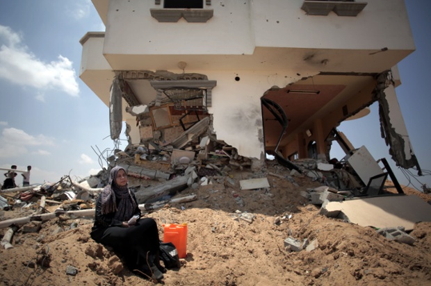 Asmahan Abu Al-Rous sits next to her destroyed house in Shawkah, Rafa. The attack on the Shawkah district was by far the heaviest shelling by the Israeli military in the Gaza war, killing nearly 100 people in one day alone.