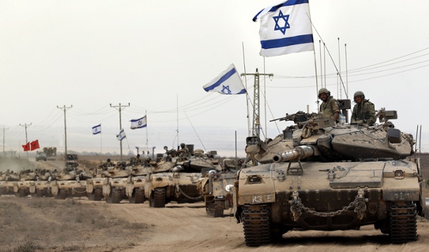 Israeli Merkava tanks return from the Gaza Strip near the border with Israel.