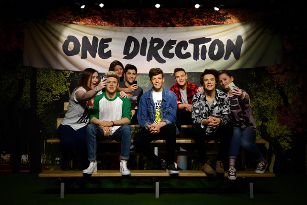 One Direction have had a summer make-over: fans pose for 'selfies' with the British boyband at Madame Tussaud's