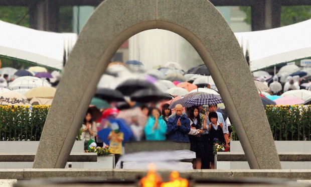Prayers are offered in the rain at the Hiroshima Peace Memorial Park in Japan