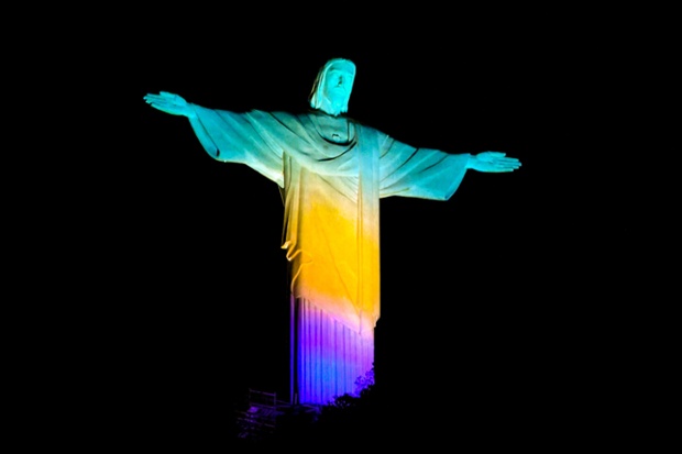 Christ The Redeemer is lit green, yellow and blue two years ahead of the Rio 2016 Olympics in Brazil
