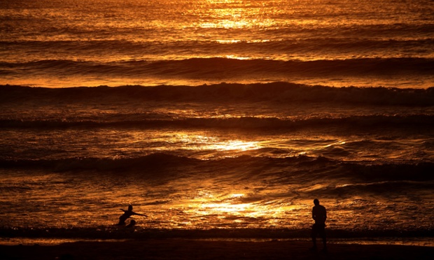 Palestinians relax on a beach in Gaza City during a 72-hour ceasefire that started on Tuesday