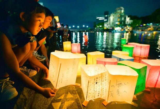 Children release paper lanterns on the Motoyasu river in remembrance of atomic bomb victims in Hiroshima, Japan