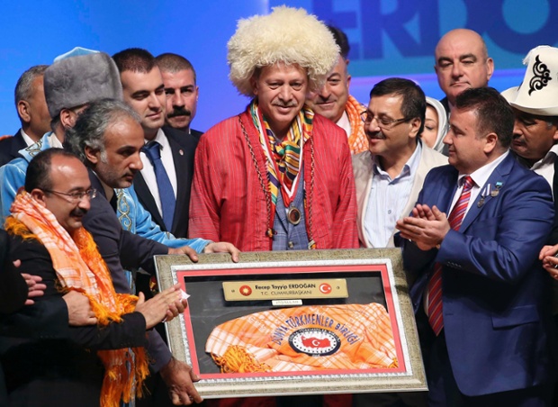 Could Turkey's Prime Minister and presidential candidate Tayyip Erdogan be touting for the woman's funny-bone vote when he posed with nomadic turkish groups in a photocall in Ankara.
