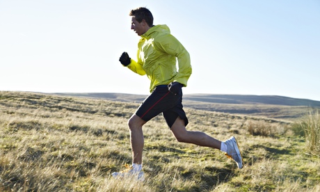 Man running in grassy field