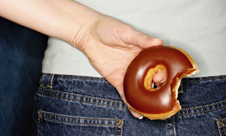 Woman with donut behind her back