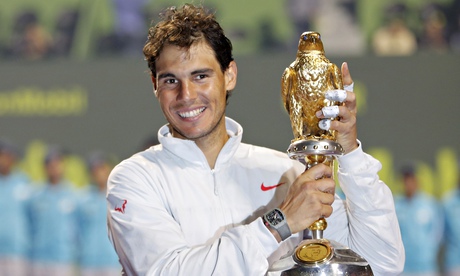 Nadal of Spain holds his trophy after winning the Qatar Open men's final tennis match in Doha