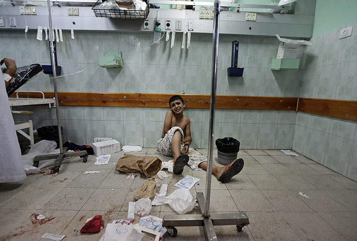 20 Photos: A Palestinian boy waits to be treated at the Kamal Adwan hospital in Gaza