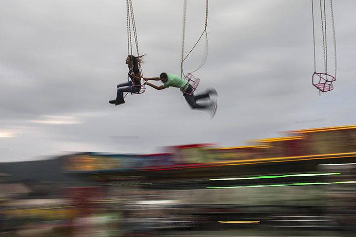 20 Photographs: Revellers ride at the brass band festival in the Serbian village of Guca
